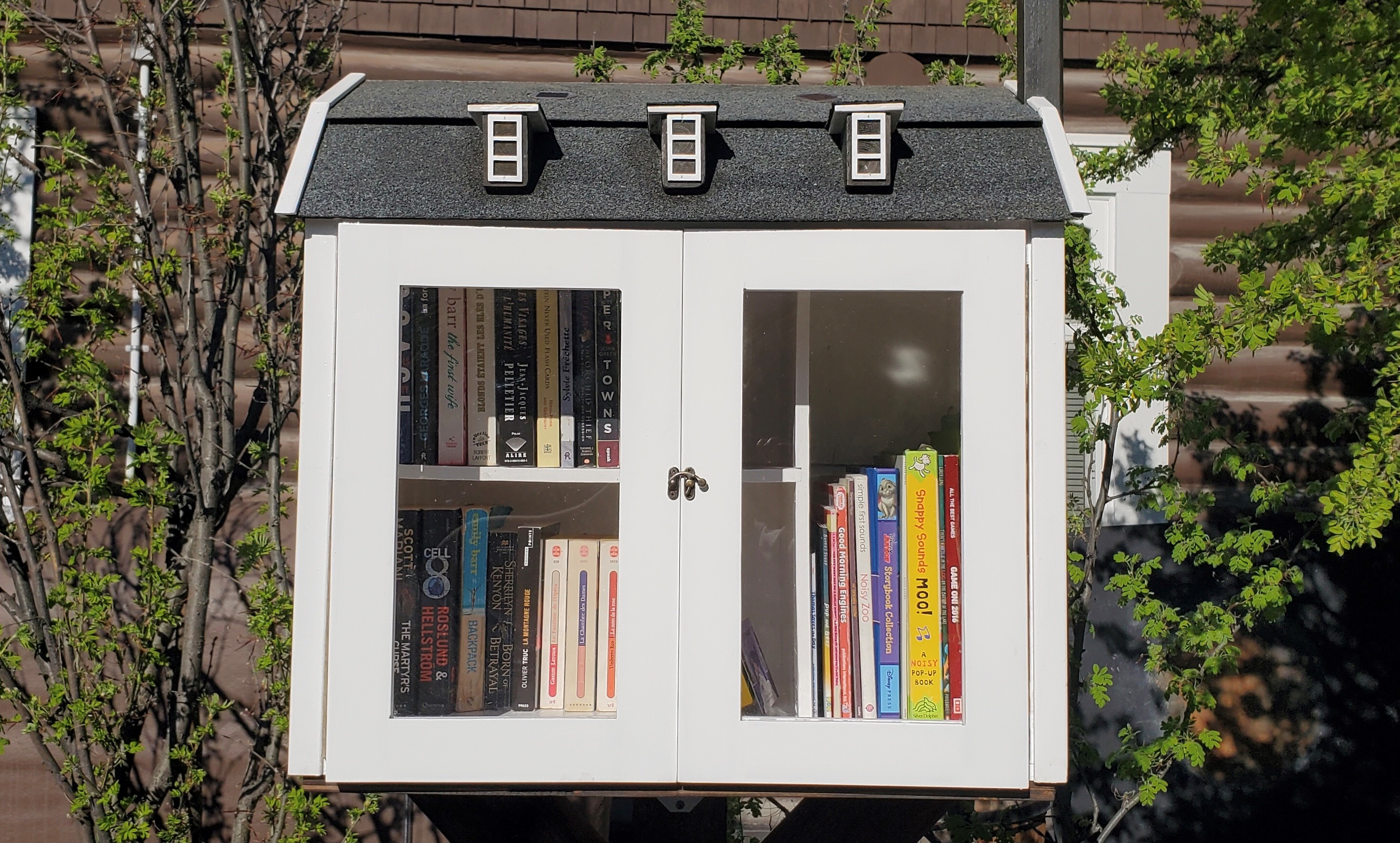 A photograph of the Commissioner of Yukon's Little Free Library outside Taylor House in Whitehorse.